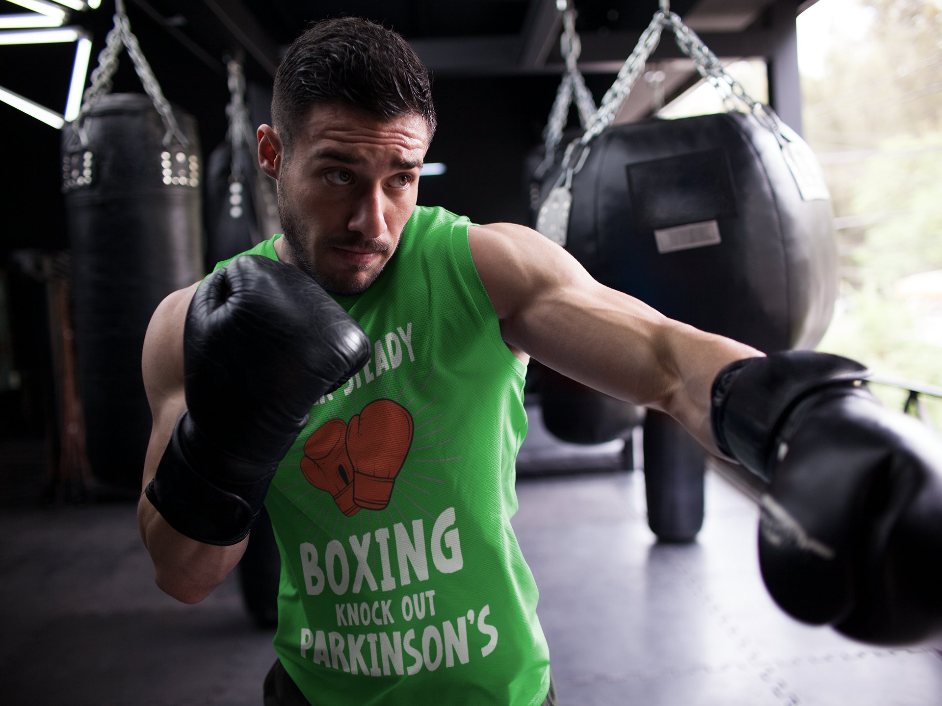 Rock Steady Boxing Parkinsons boxing vest in forest green, shadowboxing shot