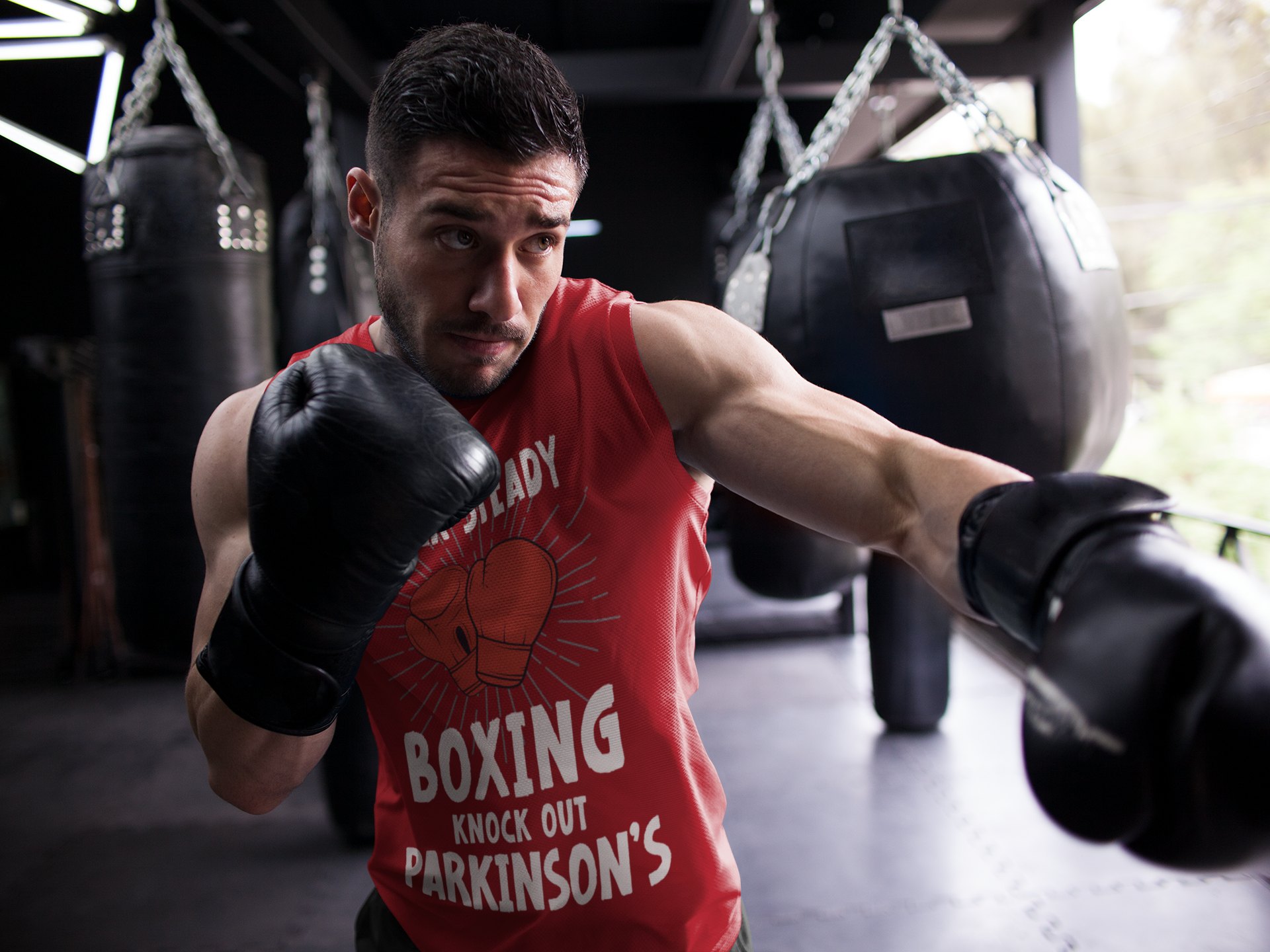 Rock Steady Boxing Parkinsons boxing vest in red, shadowboxing shot